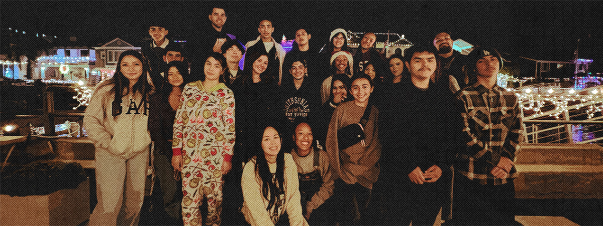 Multi ethnic youth group at beach gathering