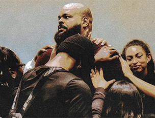 African American youth pastor getting prayed for