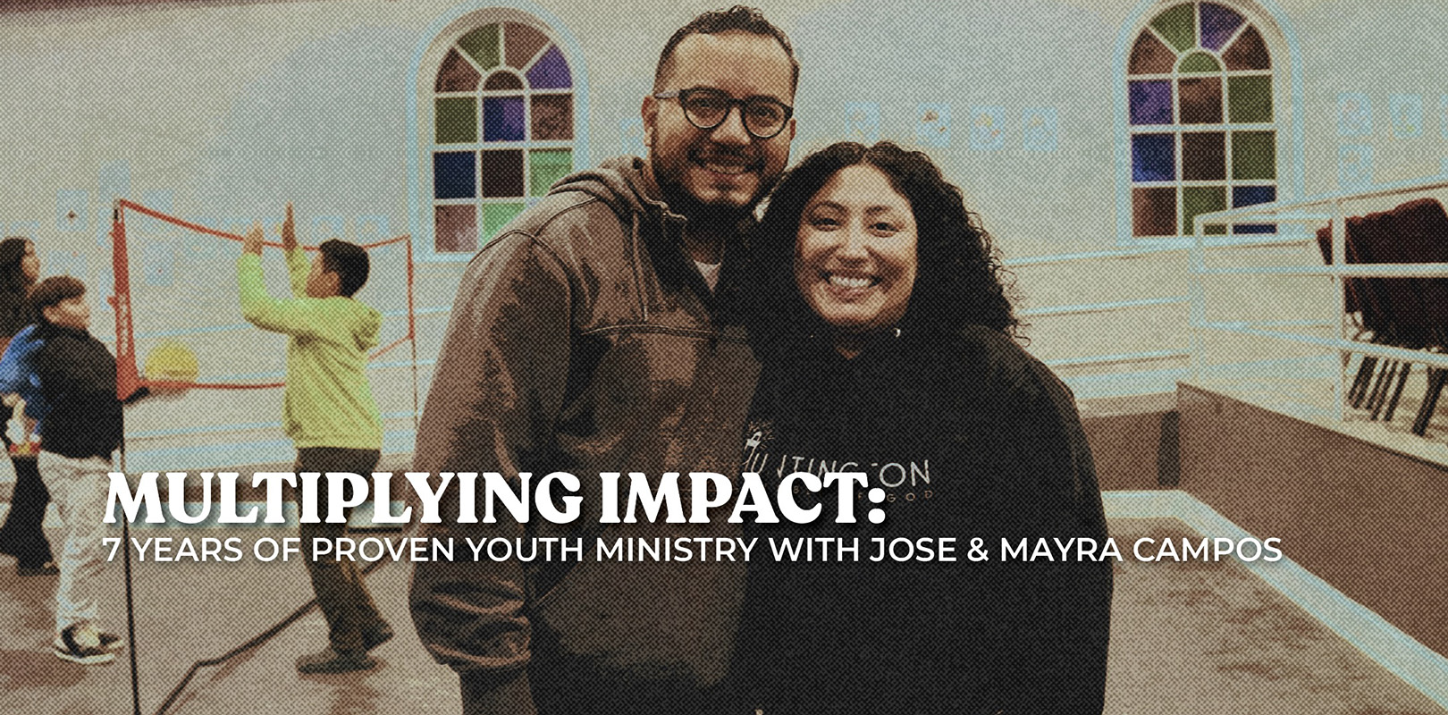 Hispanic married couple standing in front of a church