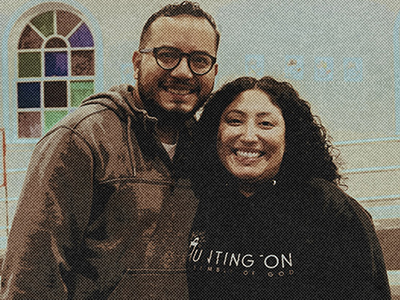 Hispanic married couple standing in front of a church