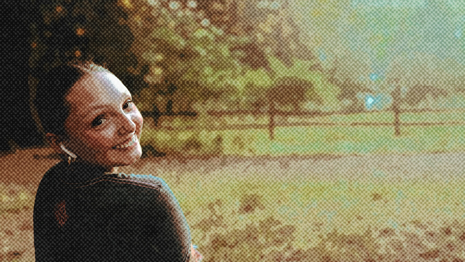 Young teenage girl looking over her shoulder in nature.